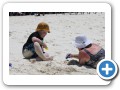 Digging in the sand with mommy.