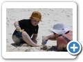 Digging in the sand with mommy.