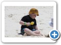 Digging in the sand with mommy.