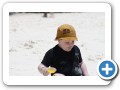 Digging in the sand with mommy.