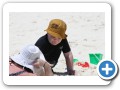 Digging in the sand with mommy.