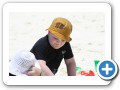 Digging in the sand with mommy.