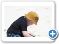 Digging in the sand with mommy.